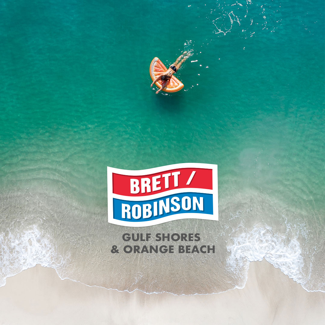 Logo of Brett / Robinson Gulf Shores & Orange beach over a beach with a person swimming in the water